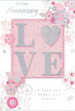 This image shows a romantic anniversary card that looks as if it has been styled with the same care as a bespoke floral arrangement delivered to a Creekmouth home. At its centre, the word LOVE is brought to life in raised, glittering letters, finished in a soft, pearlescent silver that shimmers gently rather than dazzling, evoking the sheen on fresh petals. The letters seem thick enough to be clearly felt, offering a satisfying tactile contrast against the smooth surface of the card. Surrounding this focal point, a graceful array of illustrated flowers, leaves, and swirling stems spreads across a blush pink background. The colour palette blends pastel pinks, creamy whites, and gentle greys, accented with touches of silver, creating an effect reminiscent of a delicate spring bouquet-perhaps roses, tiny blossoms, and airy foliage thoughtfully combined. Fine lines and soft shading give the impression of light filtering across the design, with each swirl and curve guiding the eye around the composition like a florist's hand turning a bouquet. Subtle decorative details-small petals, filigree curls, and faint flourishes-lend an almost dreamlike air, as if the flowers are lightly drifting across the card. An elegant script message, placed with care beneath or beside the central motif, honours the occasion with heartfelt words of enduring love and gratitude. The overall mood is one of gentle celebration and quiet intimacy, perfectly suited to marking an anniversary in Creekmouth, where thoughtful gestures and beautifully crafted details make shared milestones feel truly special.
